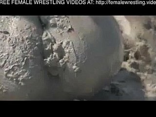 Girls wrestling all round an obstacle clay